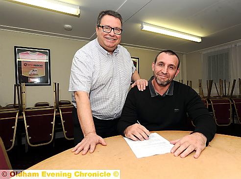 YOU’RE THE MAN: Oldham RL chairman Chris Hamilton looks on as coach Scott Naylor signs a contract to keep him at Whitebank for another three years. PICTURE: VINCENT BROWN