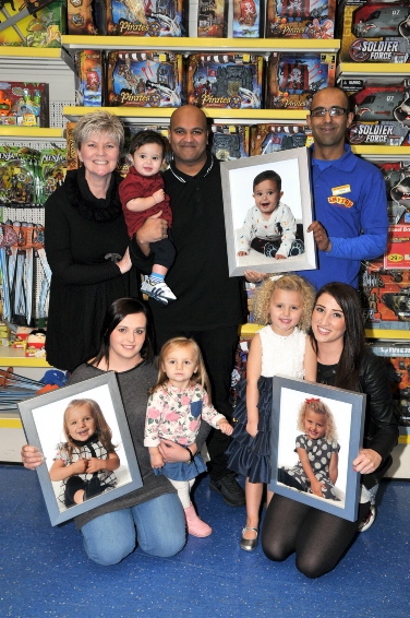 WINNERS . . . back, from the left: Gaynor Wilson (Shy Violet Photography), Harris Lohdi (10 months), Karman Lohdi, and Zahid Iqbal (Smyths Toys). Front: Michelle Aspin, Aaliyah Aspin (1), Evie Clarke (4) and Roxi Dickinson