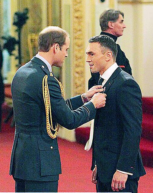 Kevin Sinfield receives his medal from Prince William at Buckingham Palace