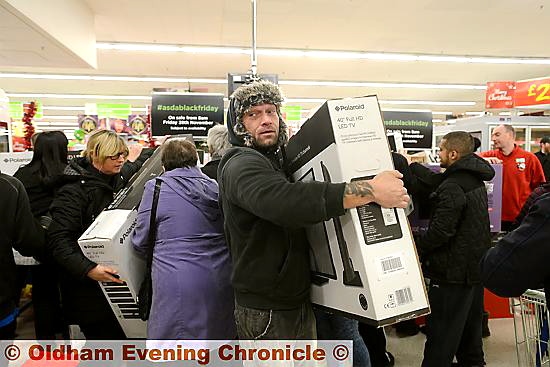 THAT’S mine . . . an eager shopper gets his hands on a new TV at Asda in Chadderton. 