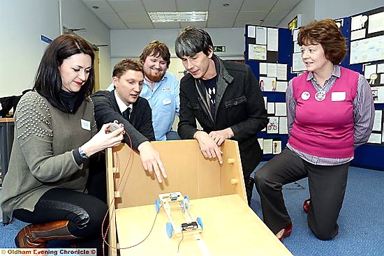 APPLIANCE of science . . . Professor Cox sees the Primary Engineering Programme in action scheme. From left, Elizabeth Schofield (St Thomas’s Leesfield School), Alex Shaw (Unity Partnership), Eddy Moores (Alston Transport) and Paula Glynn (Leesfield St. Thomas’s).