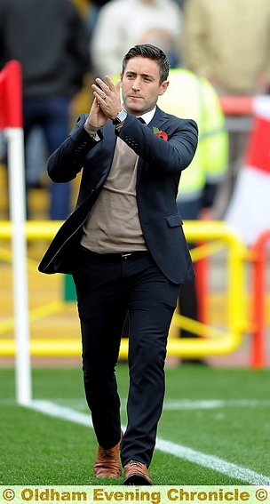 THANKS FOR YOUR SUPPORT: Lee Johnson applauds Athletic’s away following after Saturday’s game. 
