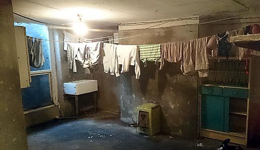 Police have released images of the squalor that they say 10 alleged slave-workers had to endure in Rochdale after two men were charged and three others arrested in connection with enslavement and trafficking offences.