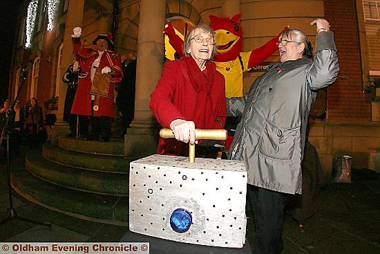 TAKING the plunge: 100-year-old Ann Lord pushes the plunger in Chadderton, cheered on by events committee member Christine Dennis