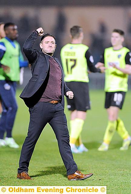 DERBY DELIGHT: Lee Johnson punches the air after victory at Spotland on Saturday. 