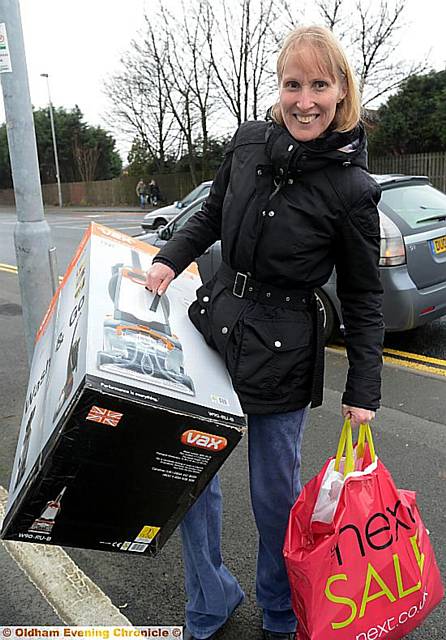 CLEANING up: Deborah Roberts, Royton, with a new vacuum cleaner and (right) shoppers at Town Square Shopping Centre