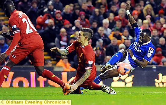 UNDER PRESSURE: Liverpool forced on the defensive as Genseric Kusunga unleashes a shot at goal.