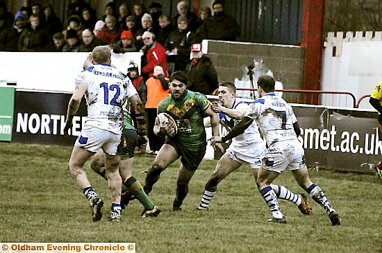 COMING THROUGH: Same Gee of Oldham comes up against three Swinton defenders 