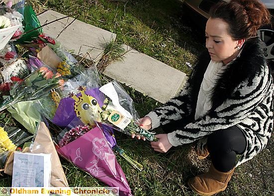 A friend of Leon’s, Rhiannon Murphy leaves flowers at the scene 
