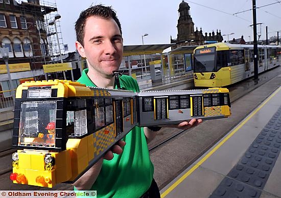 Lego master Alex Bidolak with his Metrolink tram model - with a real one in the background for reference! 
