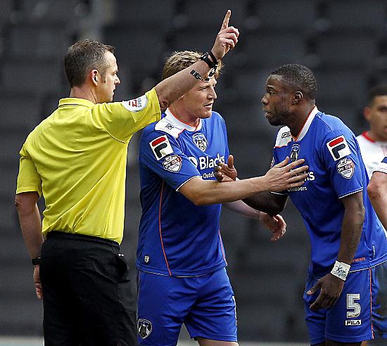 YOU’VE GOT TO GO, SON: Adam Lockwood (centre) looks on as fellow Athletic defender Genseric Kusunga gets his marching orders from referee Chris Sarginson. 