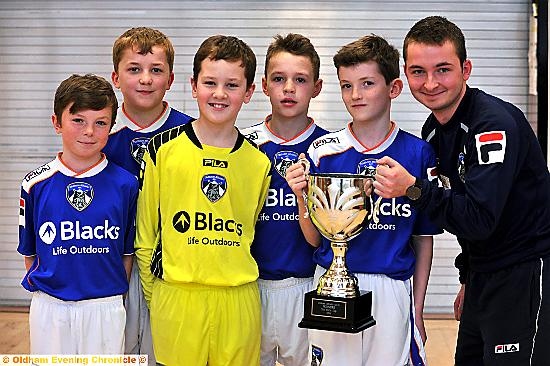 SILVER LINING . . . St Joseph’s RC Primary Schools footballers Keaton Wright (left), Tom Smith, Tom Bailey, Bailey Marsden and Patrick Killeen are pictured with Martin Vose, the OAFC Community Trust participation manager. Not on photo: Joe Hewson, Kade Wrigley. 
