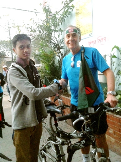 PARTING gift: Rasel Miah receives his bike from the Chronicle’s Martyn Torr, pictured wearing a headband symbol of International Mother Language Day 
