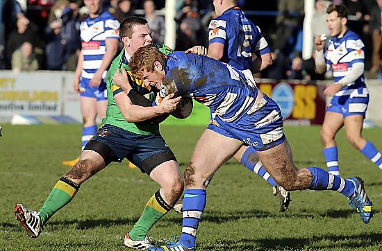 Oldham’s Adam Files gets to grips with a Barrow Raiders opponent. 
