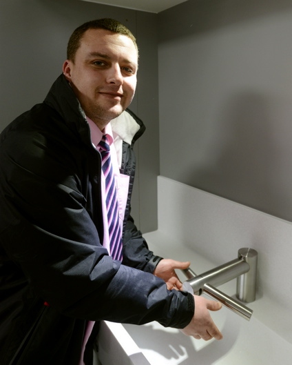 Ben Ingham demonstrates the tap in the Dyson showroom in Oldham 
