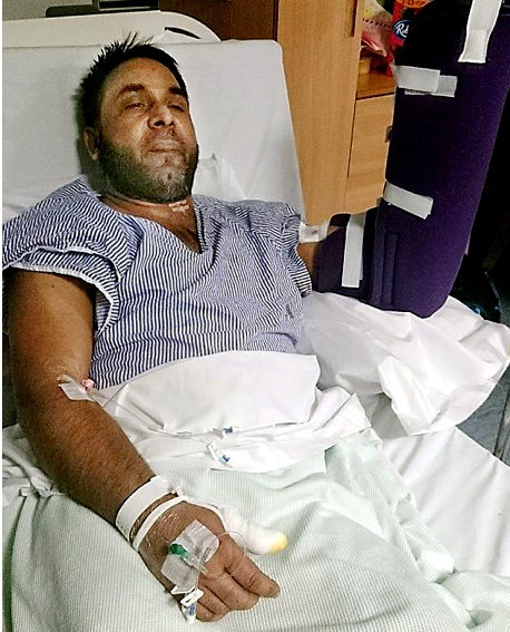 ATTACKED . . . injured driver Ashiq Pervaz lies in his hospital bed 

