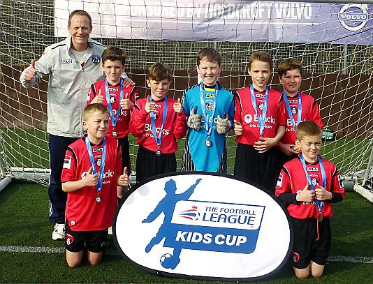 ALL SMILES . . . pictured at the Football League Kids’ Cup northern finals in Crewe with deputy headteacher Steve Hill are St Joseph’s players Bailey Marsden, Keaton Wright, Joe Hewson, Patrick Killeen, Thomas Bailey, Tom Smith and Kade Wrigley. 
SIMON SMEDLEY 
