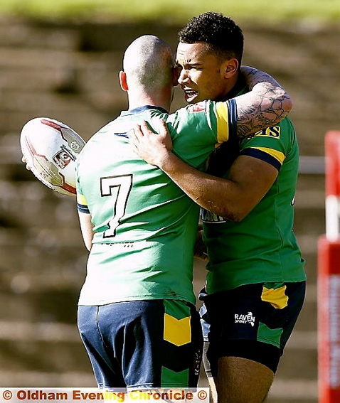 WELL DONE, SON: Edwin Okanga-Ajwang gets a hug from Brett Robinson after scoring his first try. 