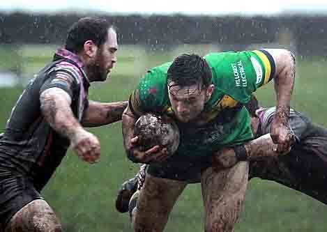 RAIN MEN . . . Oldham RL’s Paddy Mooney finds a gap in the South Wales Scorpions line. PICTURES: IAN LOVELL 
