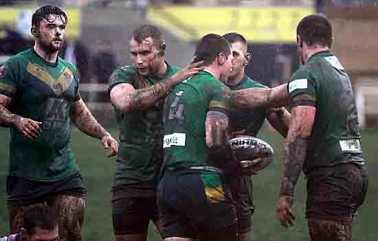 MUDDY MARVELS . . . Oldham RL players give Adam Files a pat on the back after scoring his side’s second try against South Wales Scorpions. 
