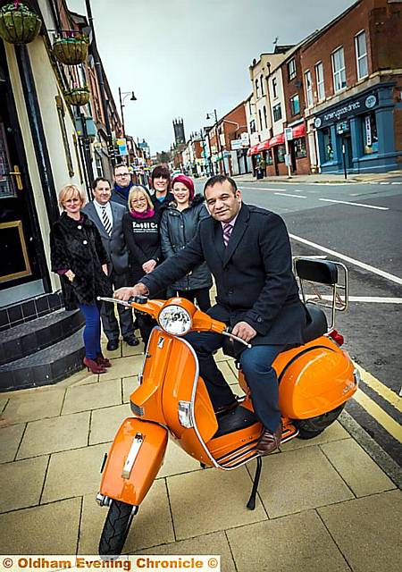 Councillor Shoab Akhtar on a scooter owned by Scoots, Suits and Boot 
