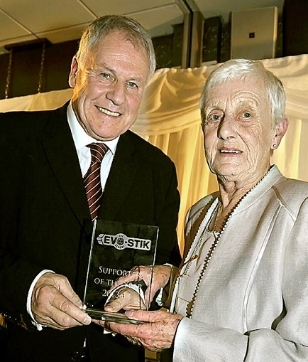 Kath receives her trophy from Joe Royle 