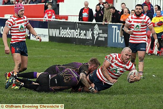 REACH OUT . . . Josh Crowley adds to Oldham’s try count just before the half-hour mark. 