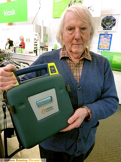 POTENTIAL lifesaver: Councillor Alan Roughley with a defibrillator unit 
