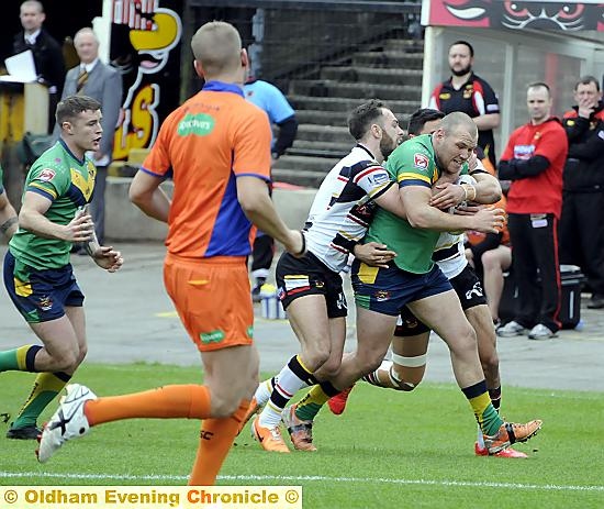 HOLDING ON: Oldham’s Josh Crowley takes it to the Bulls defence.