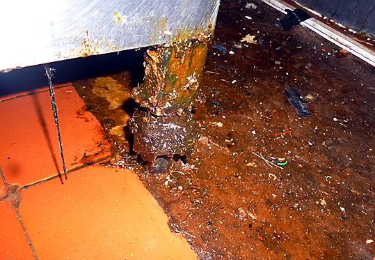 GREASE and dirt on the floor of Gold Star takeaway 
