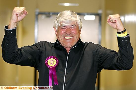 CELEBRATION . . . Warren Bates punches the air in delight after his victory over former Oldham Council leader John Battye. Picture: PAUL STERRITT 
