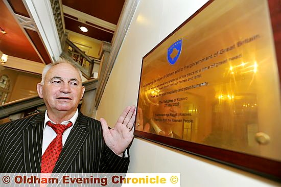 TRIBUTE . . . Osman Caka pays his respects at the plaque at Chadderton Town Hall