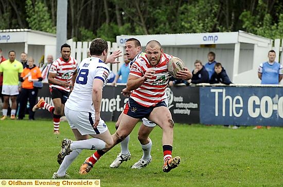 Oldham second-row man Josh Crowley goes on the outside of a Oxford opponent. 