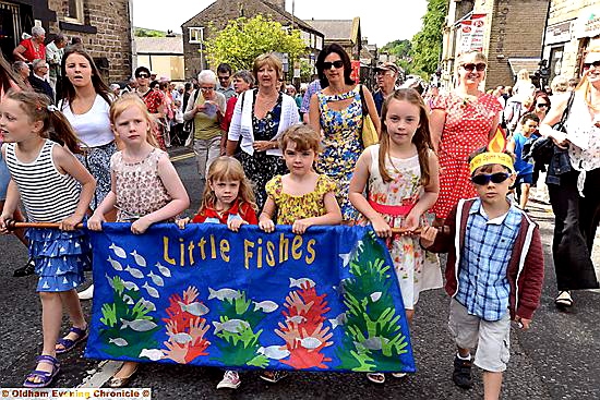 YOUNGSTERS from Uppermill Methodist Church’s Little Fishes group wore crowns with flames and carried windmills