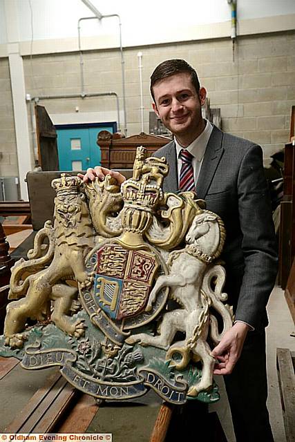 PIECE of history . . . the chandelier dating from 1913 and (below) Councillor McMahon with the crest that hung in the Old Town Hall courtroom 
