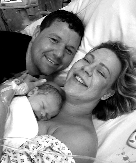 Happy family: Lisa and partner Chris cuddle up with baby Zac 
