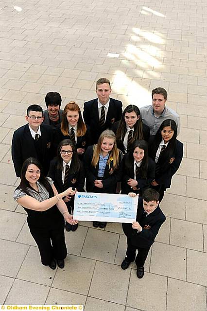 North Chadderton pupils hand over their cheque to Dr kershaw’s Lisa Pearson.