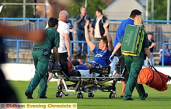 Connor Hampson waves to the crowd as he leaves the field on a stretcher.