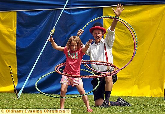 Emelia Pennington with hoola hoops with help from Harry Kingham of the Circus Sensible.