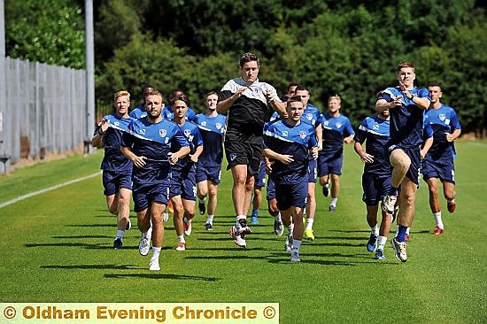 JUMP TO IT, BOSS: Athletic manager Lee Johnson leads by example as he puts his players through their paces on the first day of outdoor training.