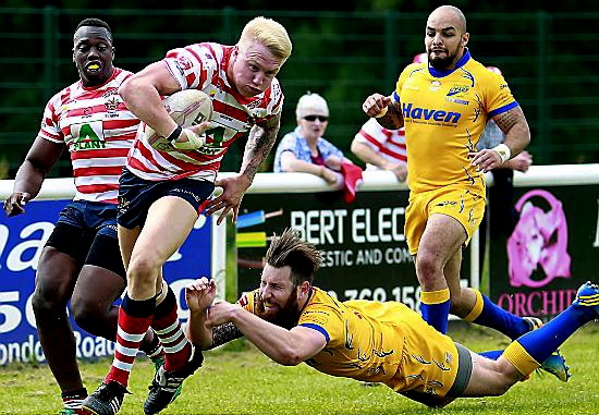 George Tyson powers through the last tackle to score for Oldham during the Hemel Stags game in early June