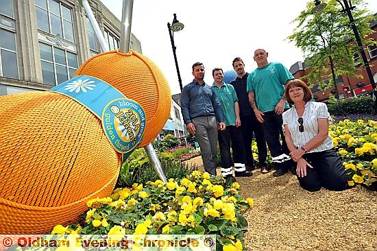 TIGHT knit group . . . pictured at the town centre display are Councillor Barbara Brownridge (kneeling) with, from the left, council greenspace officer Paul Byrne, council gardener Andrew Marsland, Dr Kershaw’s Hospice community fundraiser Aaron Cheshire and council gardener John Hickey. PICTURE: Darren Robinson
