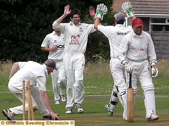 Andrew Jones celebrating with his team mates after claiming a wicket