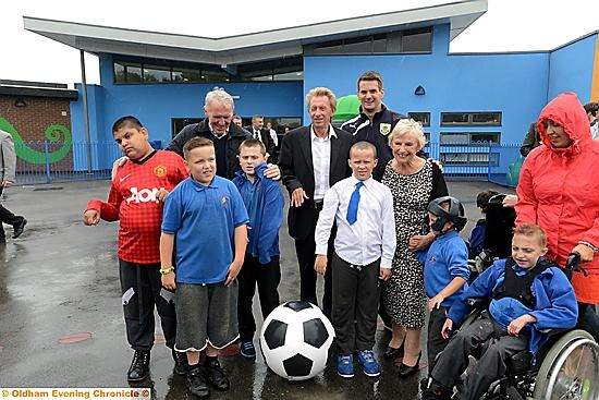 READY for a game . . . at the opening of the new outdoor learning centre at Kingfisher School are (back, from the left) former Manchester United player players Paddy Crerand and Denis Law, Burnley FC goalkeeper Tom Heaton and Sheila Crompton, with pupils (front, from the left) Usayd Khan, Brandon Lawrence-Gate, Louis Smeaton, Junior Burke, Jayden Das and Logan Bond