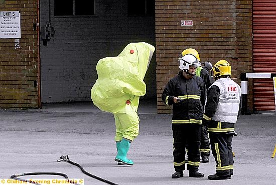 A FIREFIGHTER in specialist protection suit at the scene