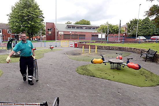 COUNCIL workmen tidy up the mess left by vandals.