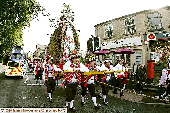 HIGH and mighty . . . the rushcart parades through Uppermill