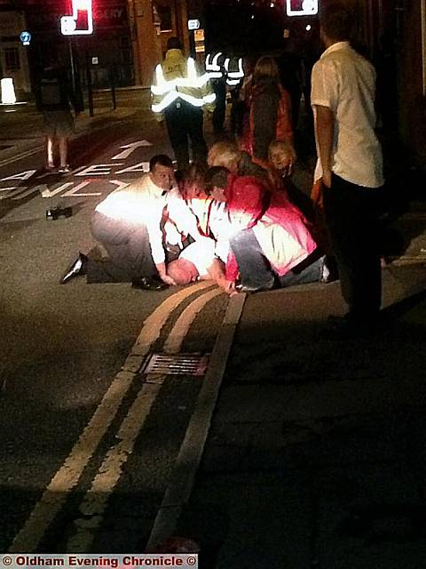 TEAM work . . . the Street Angels pull together to help a young man knocked unconscious in a street brawl