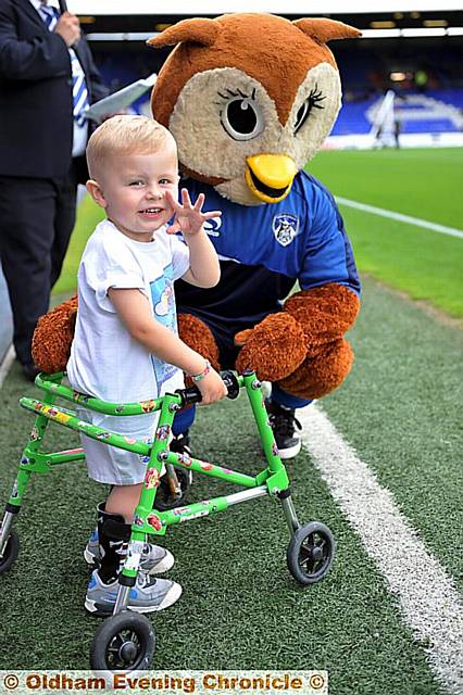 Leo Stott with Chaddy the Owl as he leads latics out against Huddersfield Town