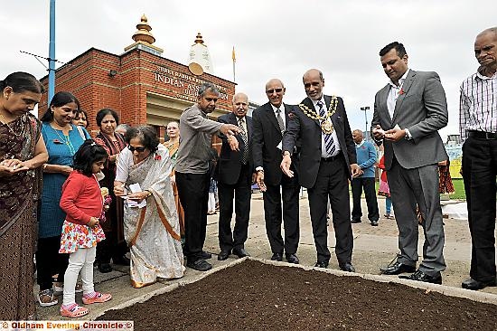 Tribute to the fallen during World War One at the Indian Association, Oldham. Guests scatter poppy seeds.